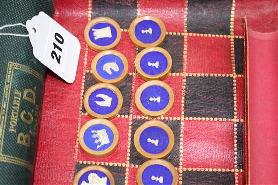 A 19th century Jaques Patent portable B.C.D. backgammon, chess and draughts board set, the gilt tooled red morocco cylinder holder